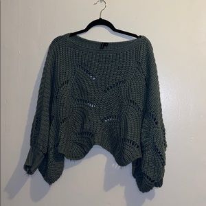 Green sweater with cutouts